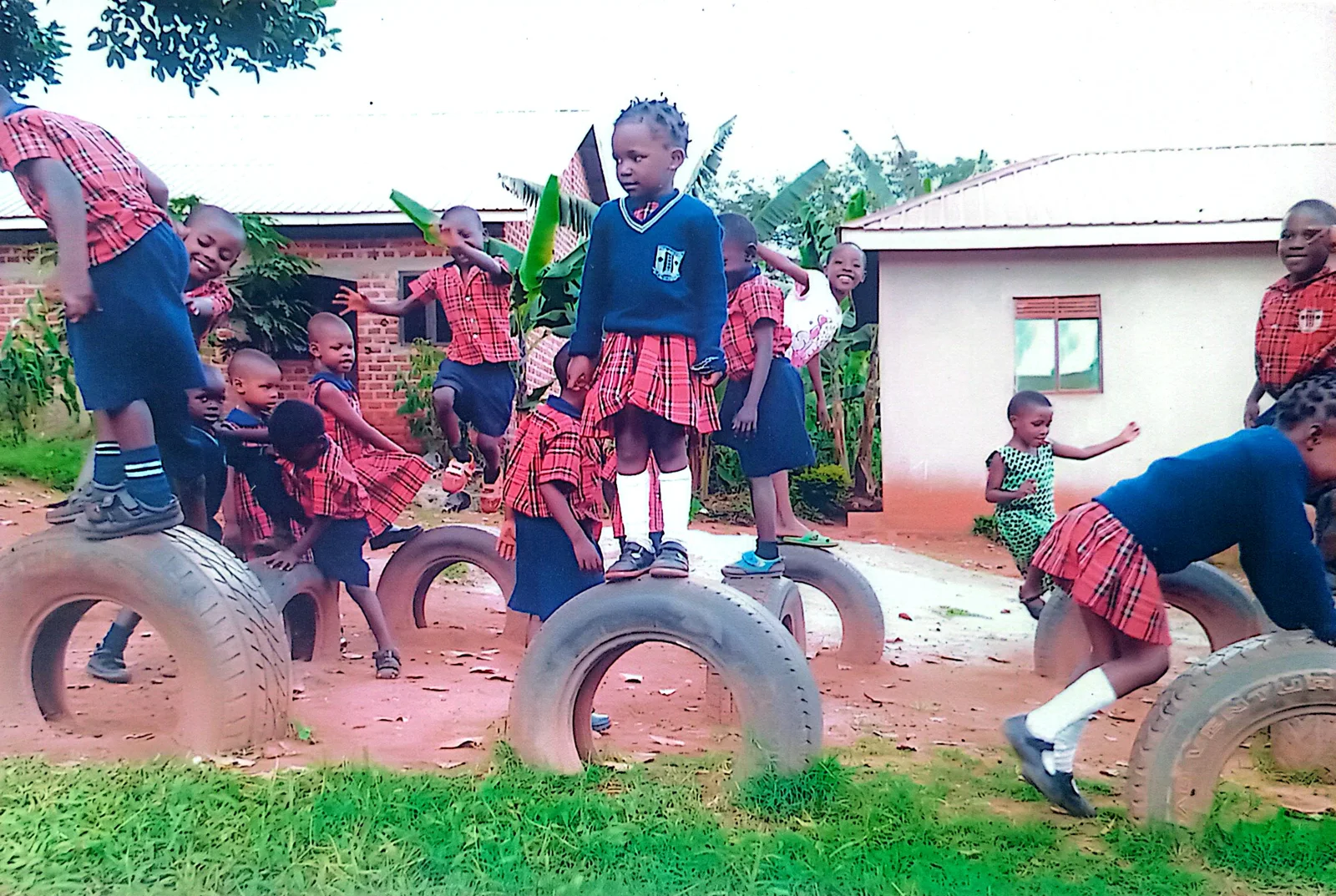 Pupils playing together on playground equipment at Josianah Junior School