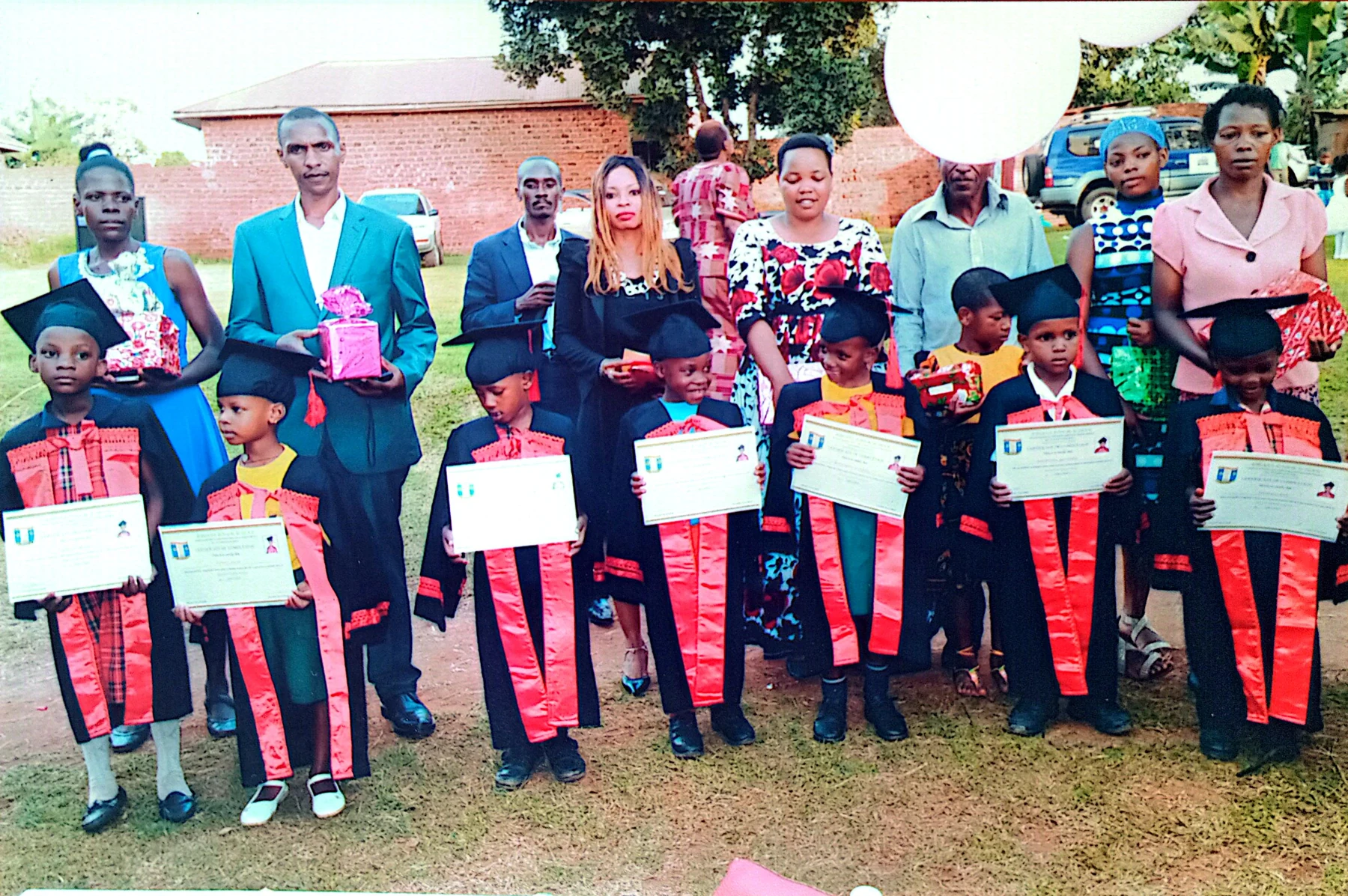 Children and staff celebrating together in the school grounds